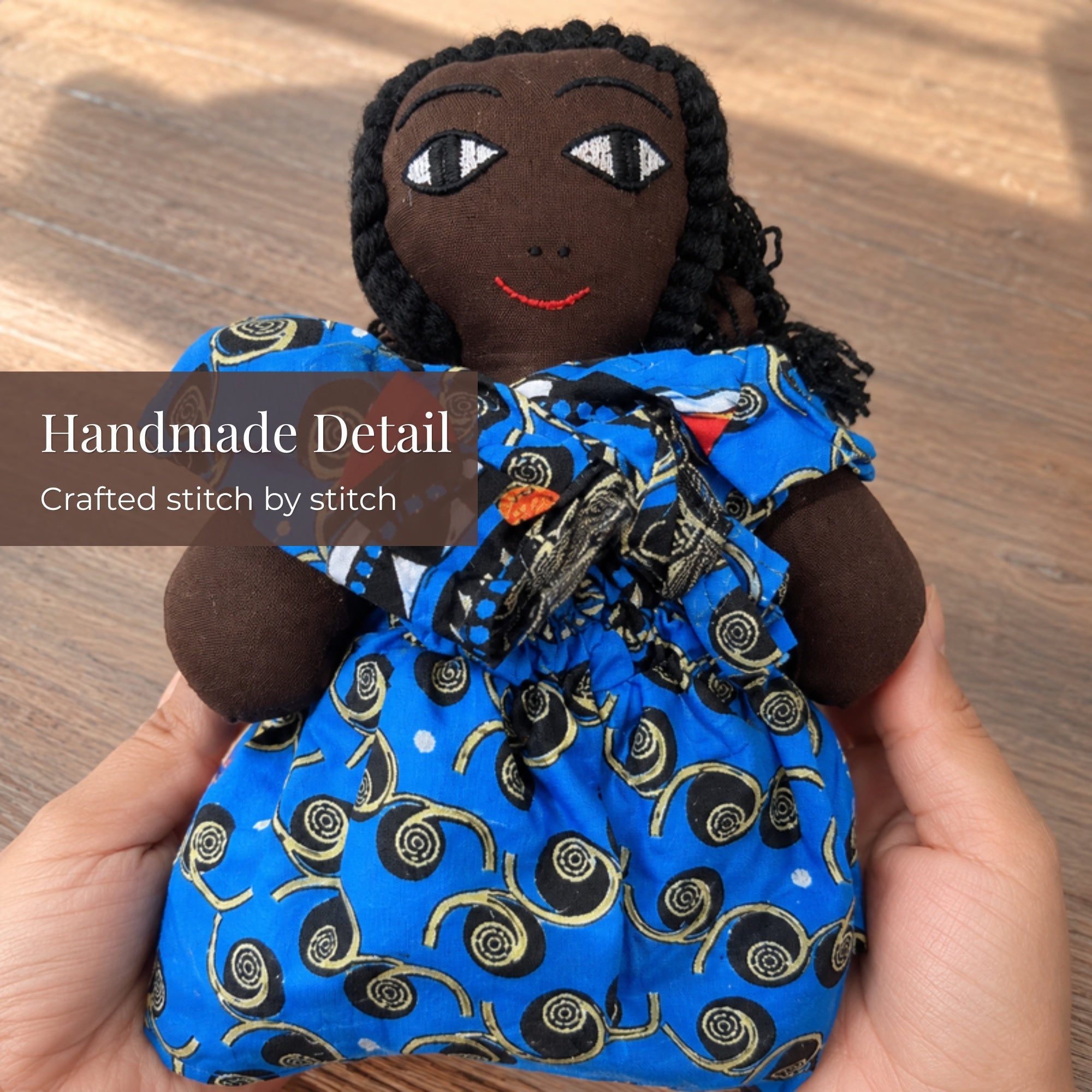Handmade African fabric doll detail – hand-stitched craftsmanship, Ghanaian artisan collectible. African Delights.